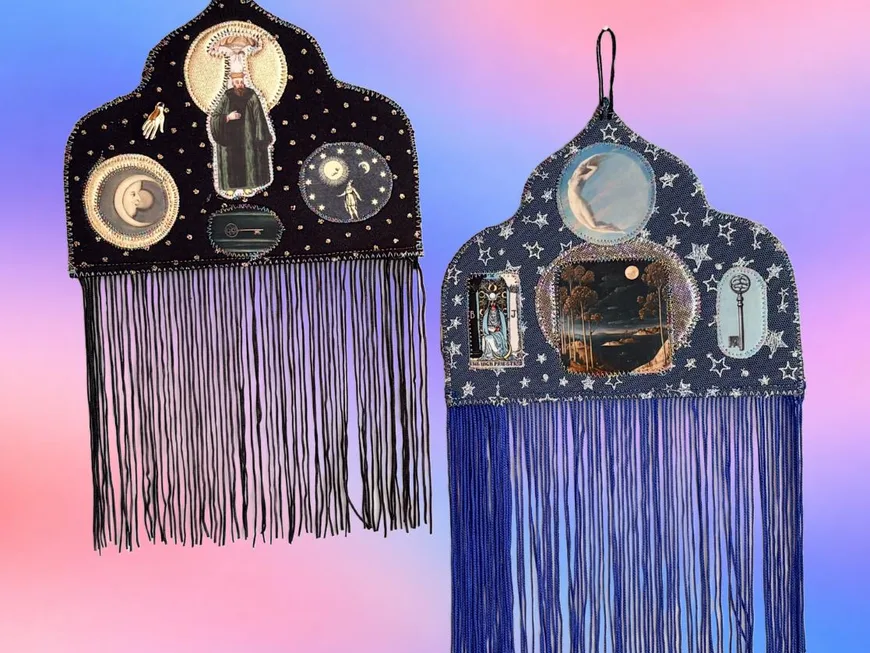 Two black fringed moon talismans with small framed pictures